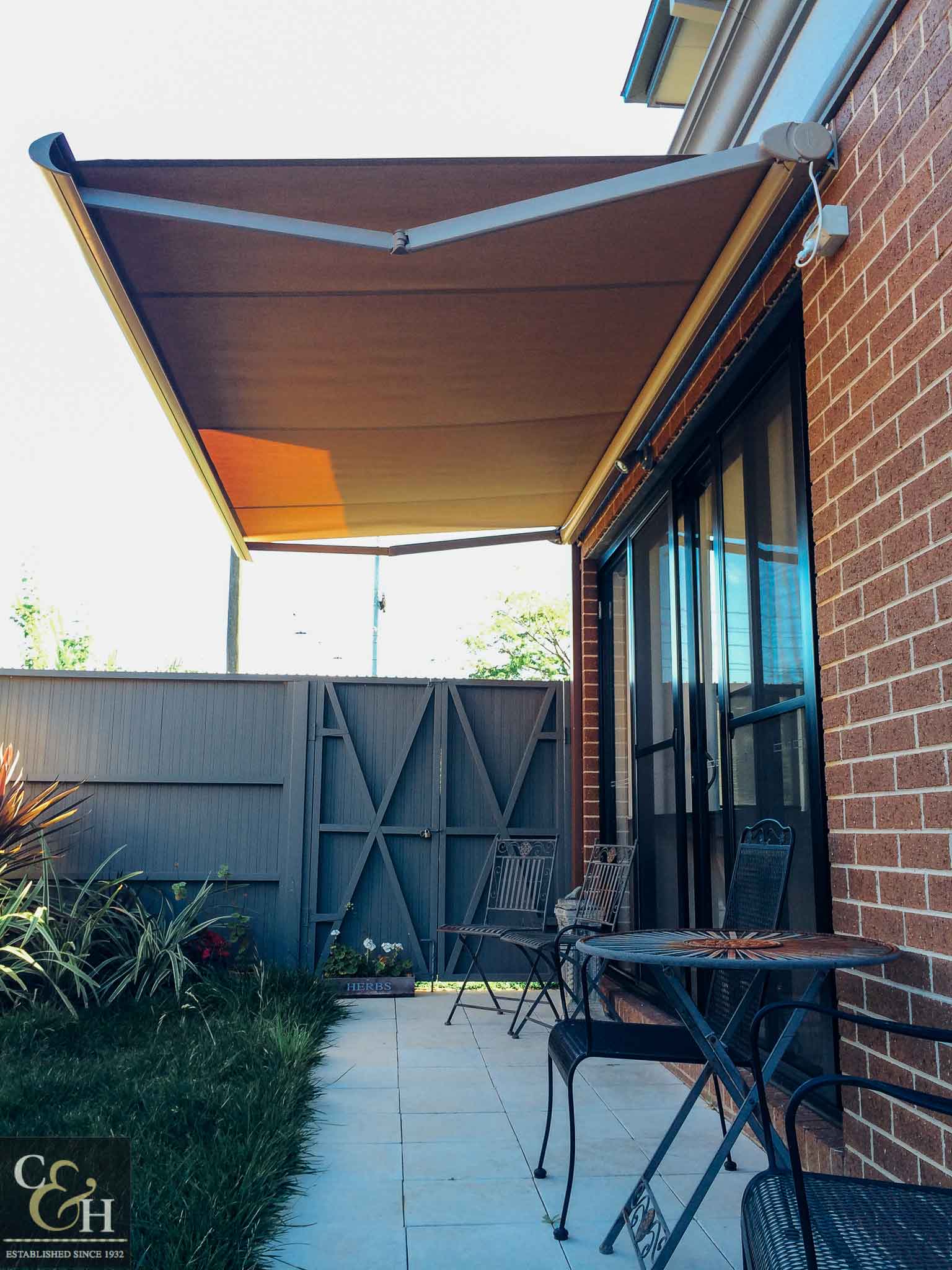 Brustor-B50-Full-Cassette-Folding-Arm-Awnings-12 outside a house