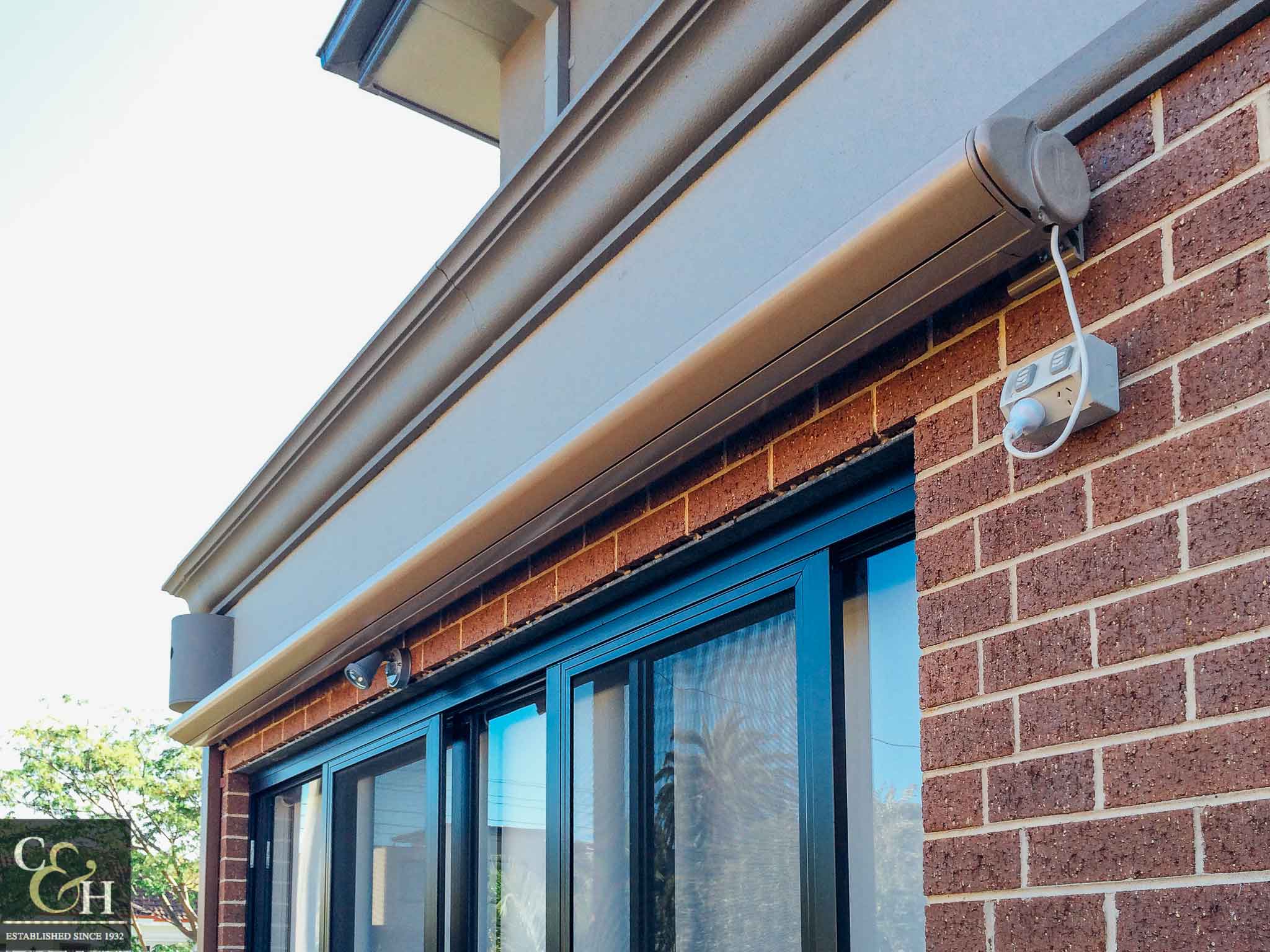 Brustor-B50-Full-Cassette-Folding-Arm-Awnings-13 outside a house