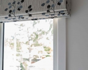 Designer fabric roman blinds 46 on a window.