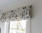 Designer fabric roman blinds 48 on a window.