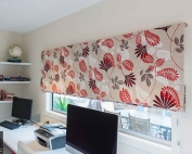 Designer fabric roman blinds 51 on a window.