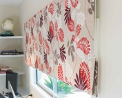 Patterned roman blinds 52 on a window.