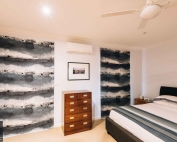 A bedroom with roman blinds 60 from Campbell & Heeps
