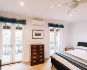 A bedroom with roman blinds 62 from Campbell & Heeps